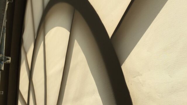 Zoom sur la demie-lune du store enrouleur motorisé géant Gauthier & compagnie au musée du Louvre